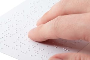 a hand touching braille