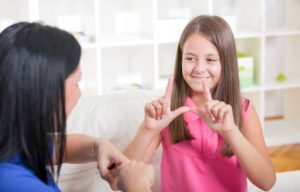 Deaf woman and child learning sign language