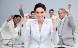 Happy business people celebrating a sucess with hands up