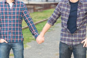 two men holding hands