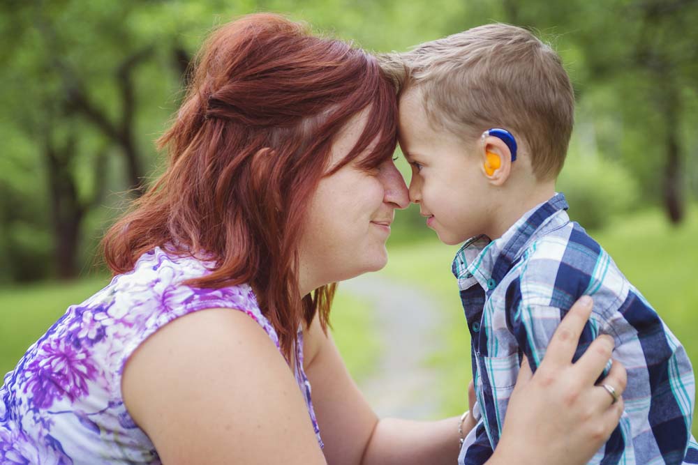 Mother and son in forest having fun